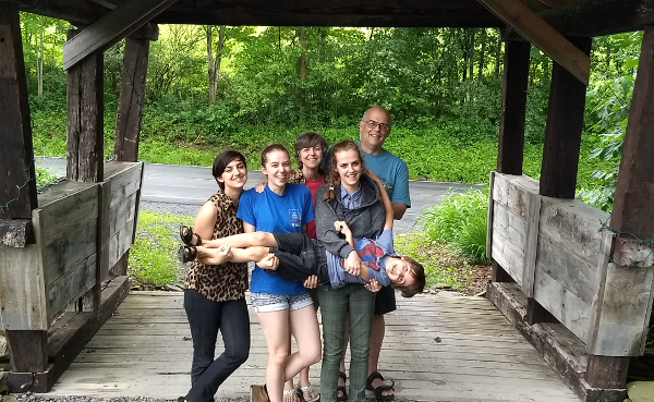 Robb with family and friends at a covered bridge